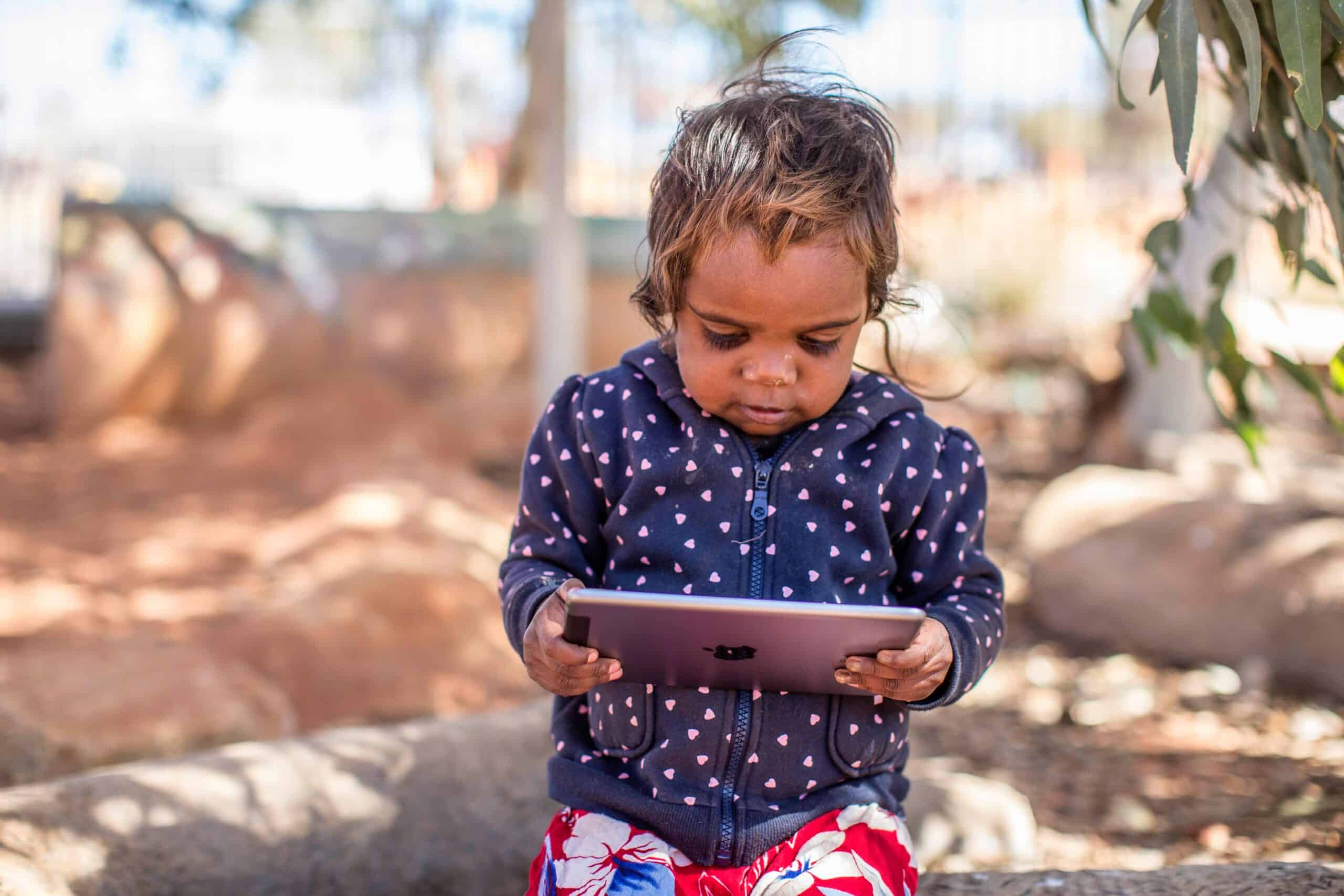 child looking at digital device
